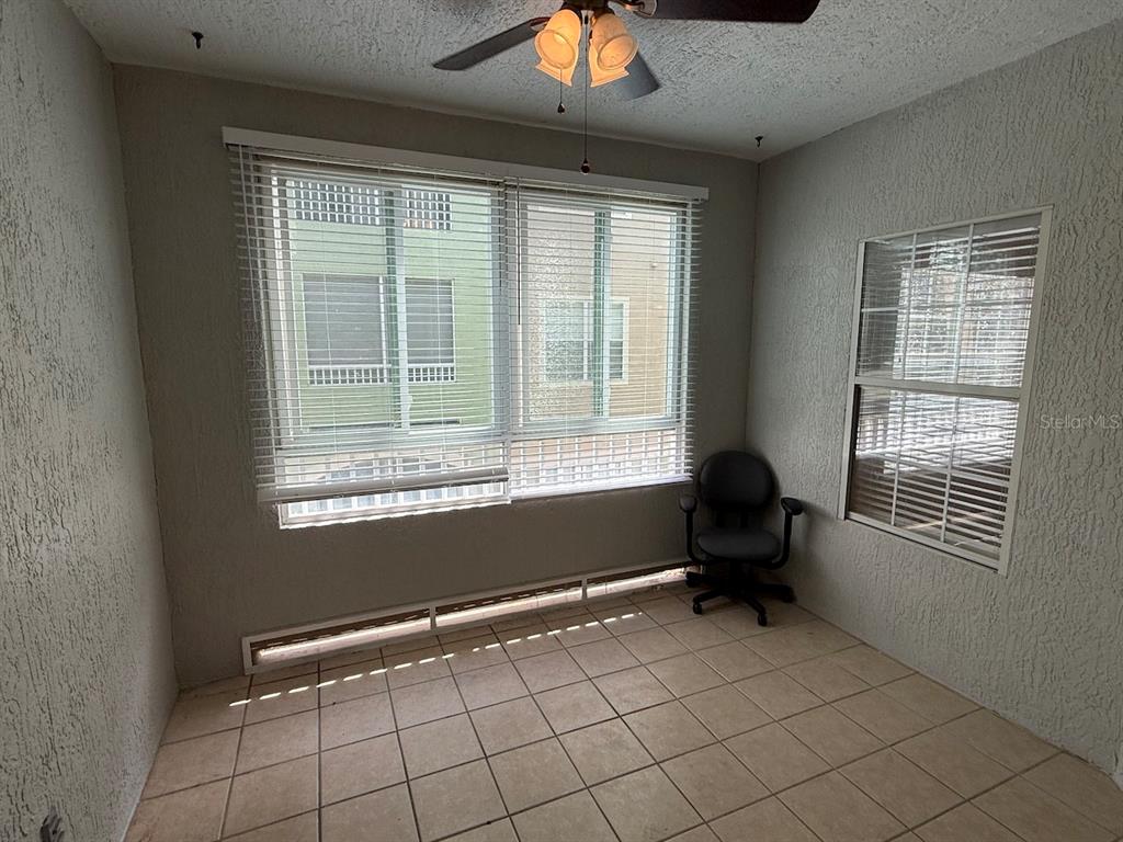 4817 Cypress Woods Drive, Unit 5203 Orlando, FL 32811 - Photo 11 of 22 a room with window and furniture