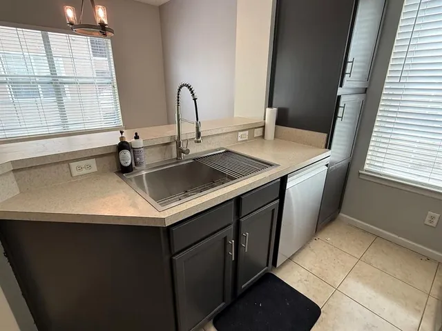 a kitchen with a sink and a window
