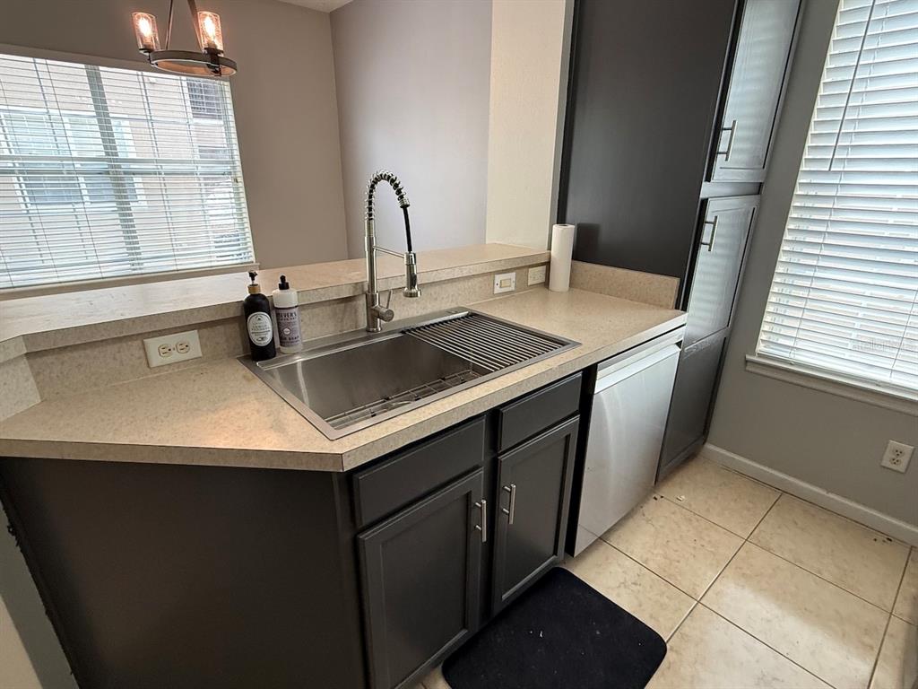 4817 Cypress Woods Drive, Unit 5203 Orlando, FL 32811 - Photo 9 of 22 a kitchen with a sink and a window