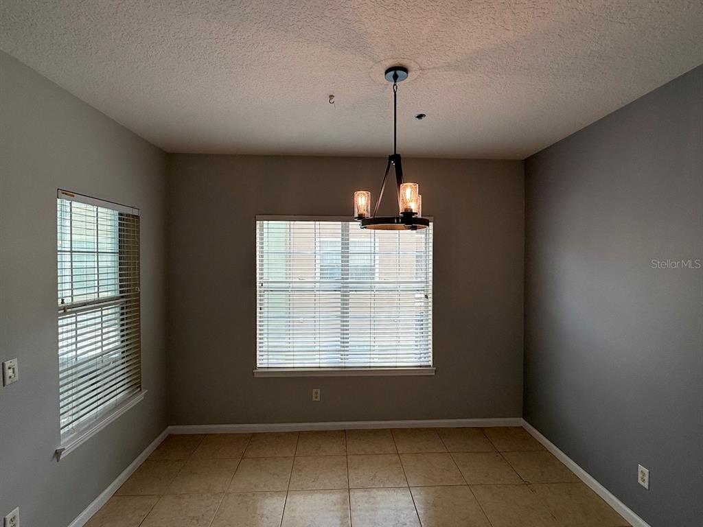 4817 Cypress Woods Drive, Unit 5203 Orlando, FL 32811 - Photo 10 of 22 a view of empty room with windows