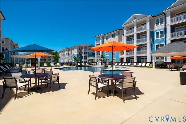 a patio with a table and chairs under an umbrella