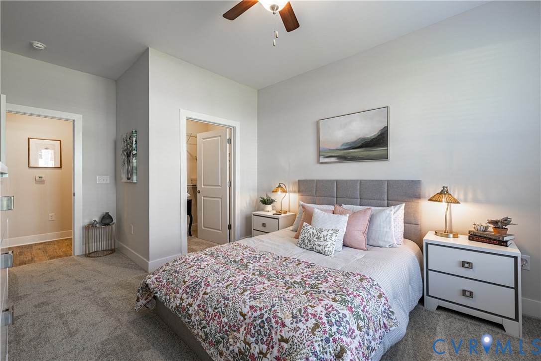 10525 Stony Blf Drive, Unit 204 Ashland, VA 23005 - Photo 21 of 36 a bedroom with a bed and a chandelier