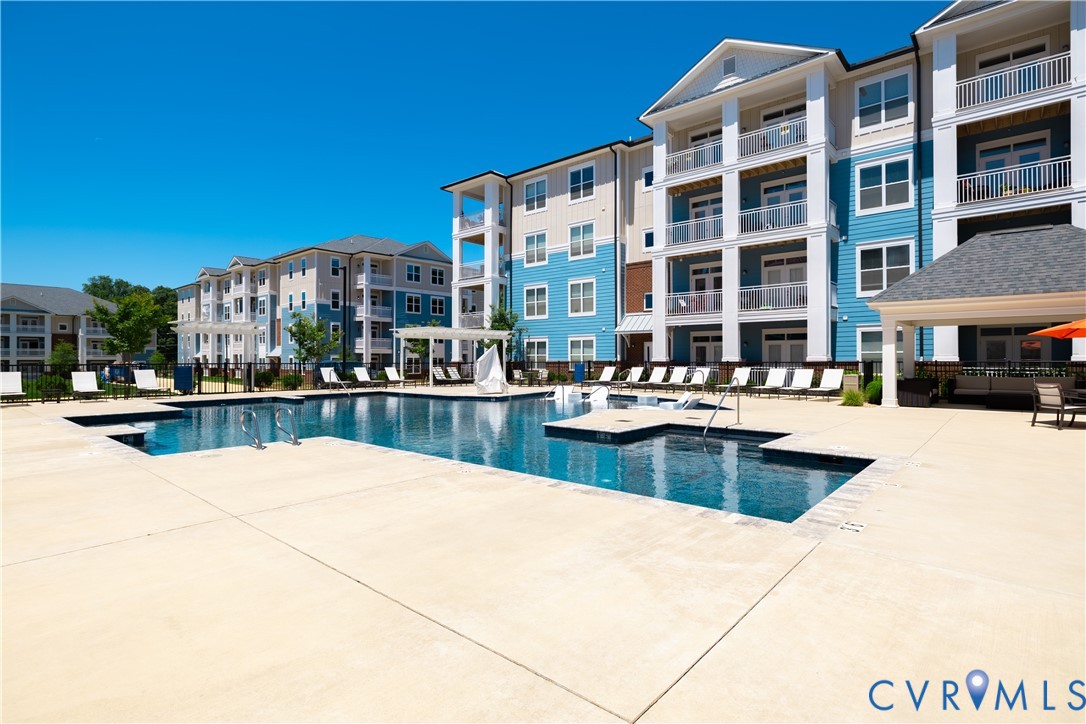 10525 Stony Blf Drive, Unit 204 Ashland, VA 23005 - Photo 4 of 36 a view of a swimming pool and a buildings