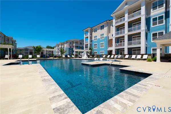 a swimming pool view with a outdoor seating