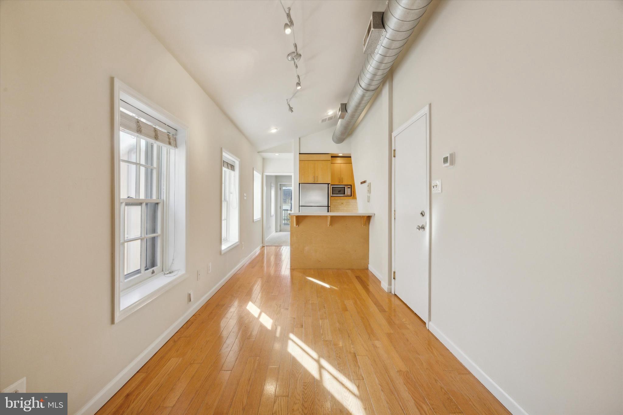 2032 Pine Street, Unit 2 Philadelphia, PA 19103 - Photo 1 of 13 a view of a big room with wooden floor and windows