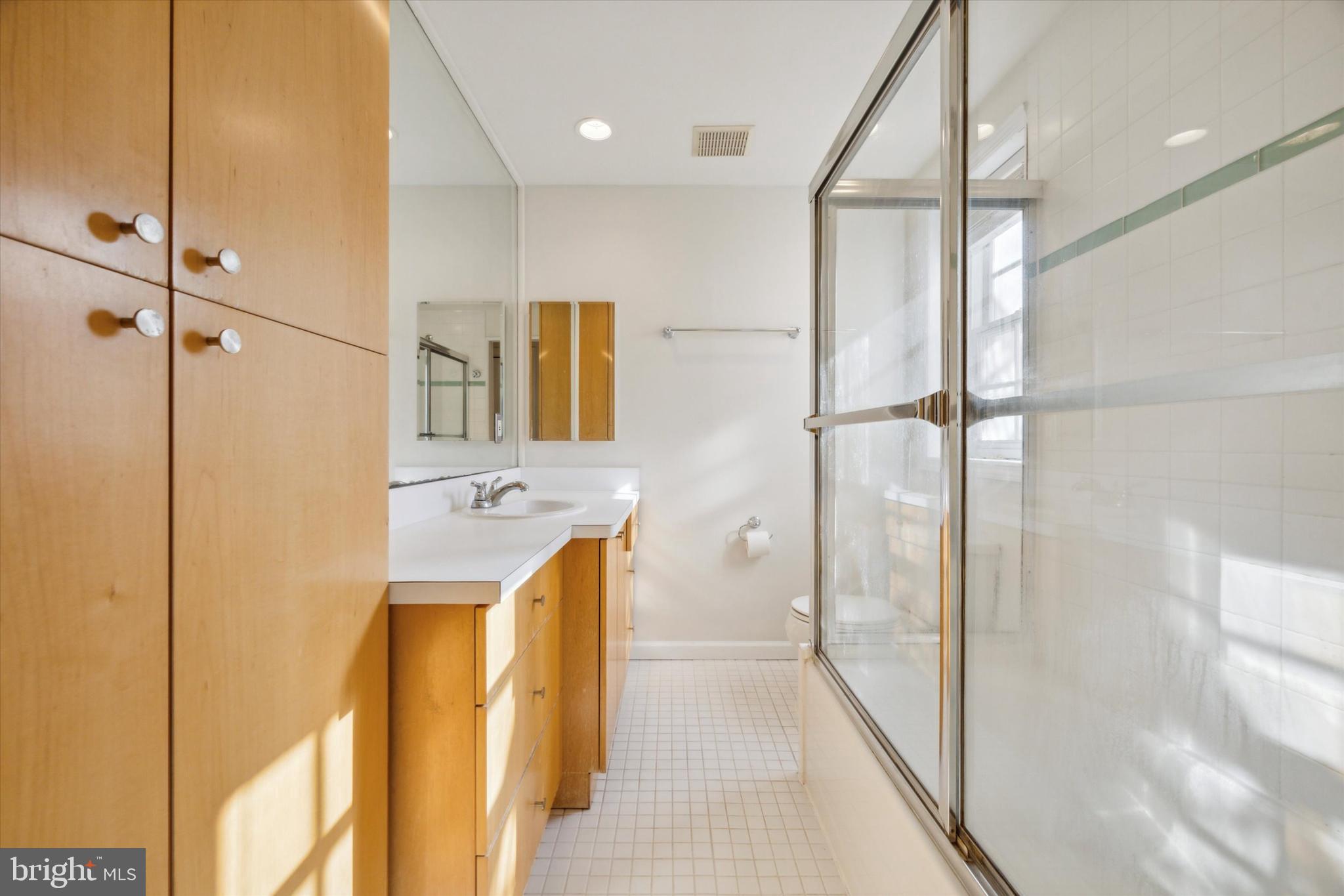 2032 Pine Street, Unit 2 Philadelphia, PA 19103 - Photo 3 of 13 a bathroom with a sink a mirror and a shower