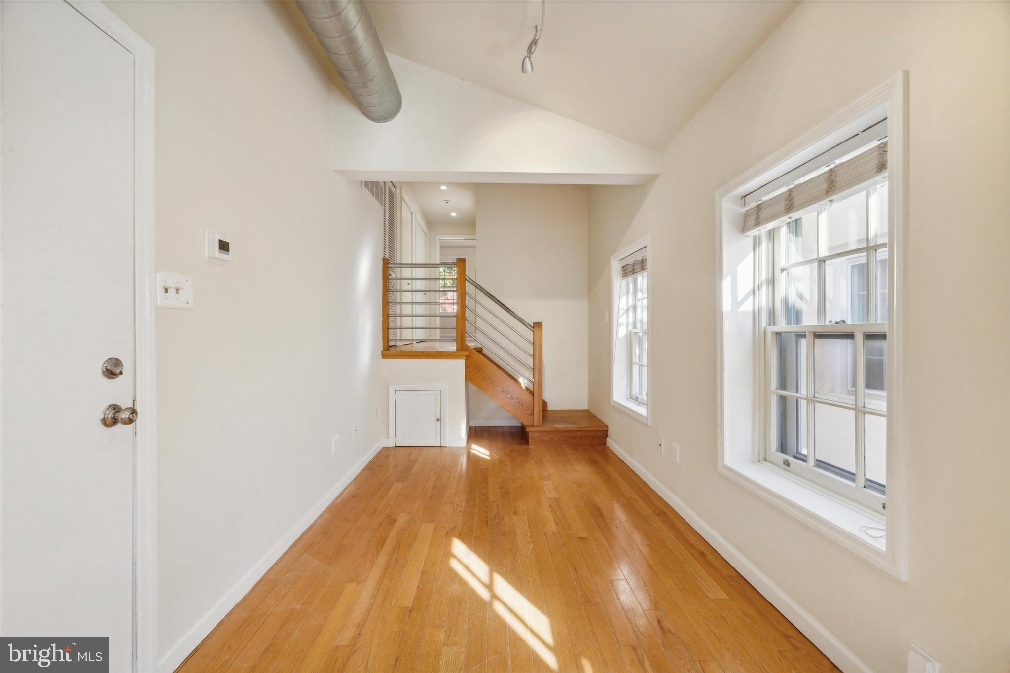 2032 Pine Street, Unit 2 Philadelphia, PA 19103 - Photo 5 of 13 a view of a room with wooden floor and windows