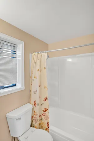 a bathroom with a bathtub and shower