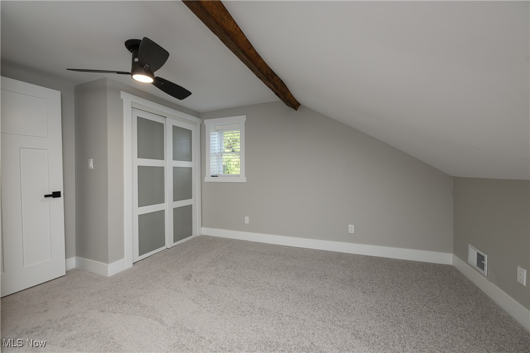 3029 Werner Church Road Northeast Canton, OH 44721 - Photo 24 of 33 Additional living space with ceiling fan, vaulted ceiling with beams, and carpet