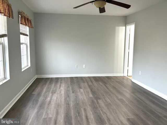 wooden floor in an empty room with a window