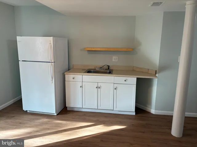 a kitchen with a stove a refrigerator and a cabinets