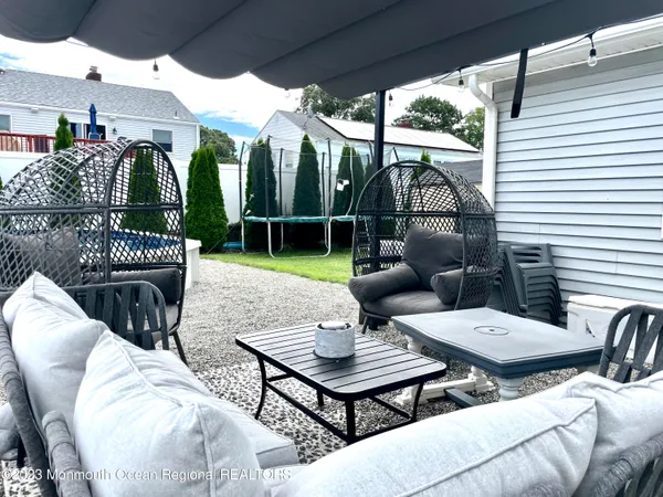 a view of a patio with couches table and chairs and potted plants