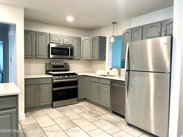 a kitchen with a refrigerator stove and microwave