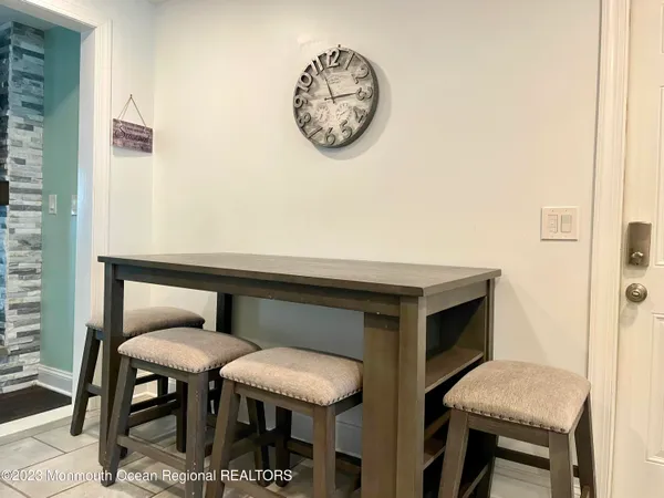 a bathroom with a table and a chair