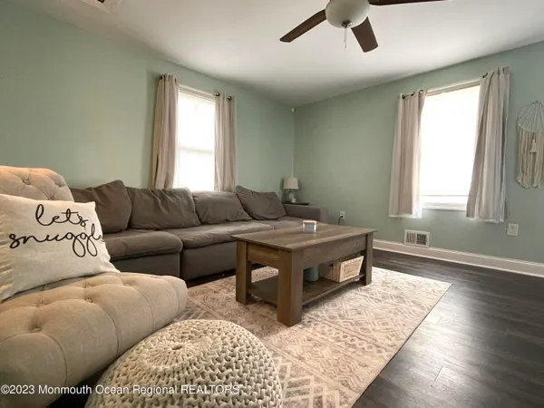 a living room with furniture rug and window