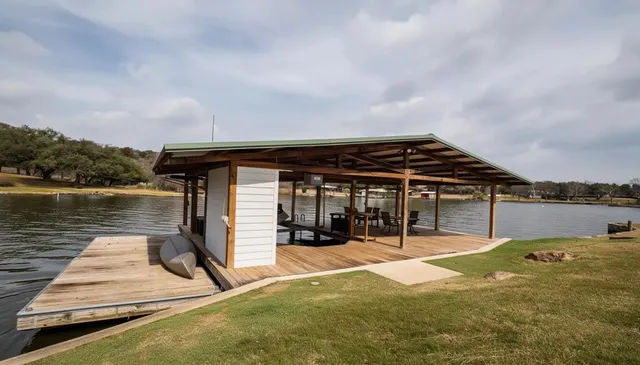 a backyard of a house with table and chairs