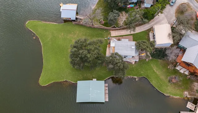 an aerial view of a house with a lake view