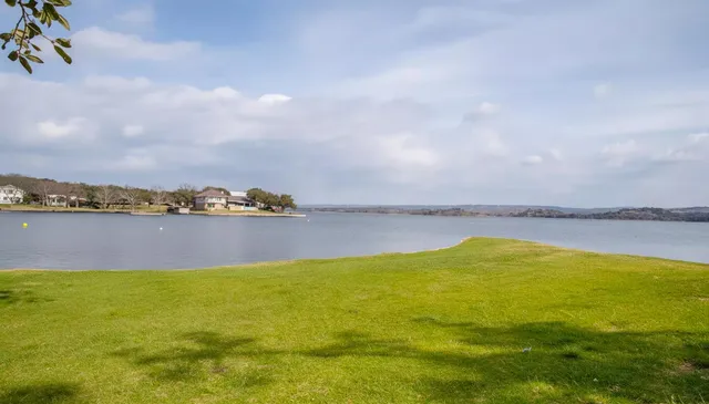 a view of a house with large windows and a large tree