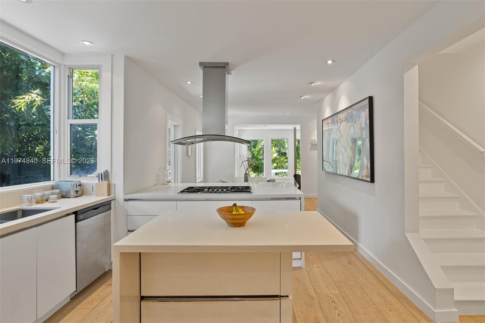 4286 Douglas Road Miami, FL 33133 - Photo 11 of 51 a kitchen with a stove a sink and a refrigerator