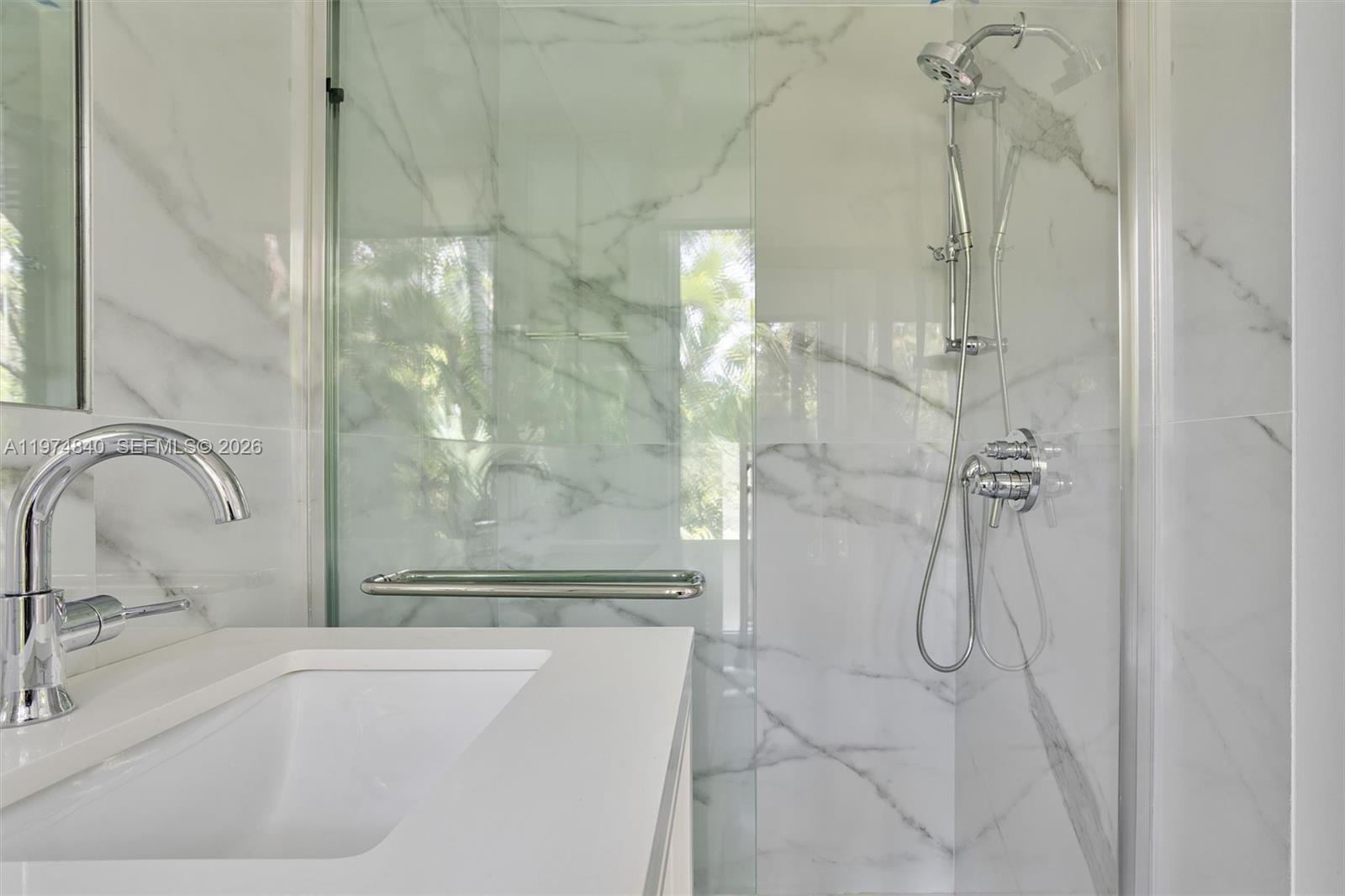 4286 Douglas Road Miami, FL 33133 - Photo 27 of 51 a bathroom with a granite countertop shower a sink and a mirror