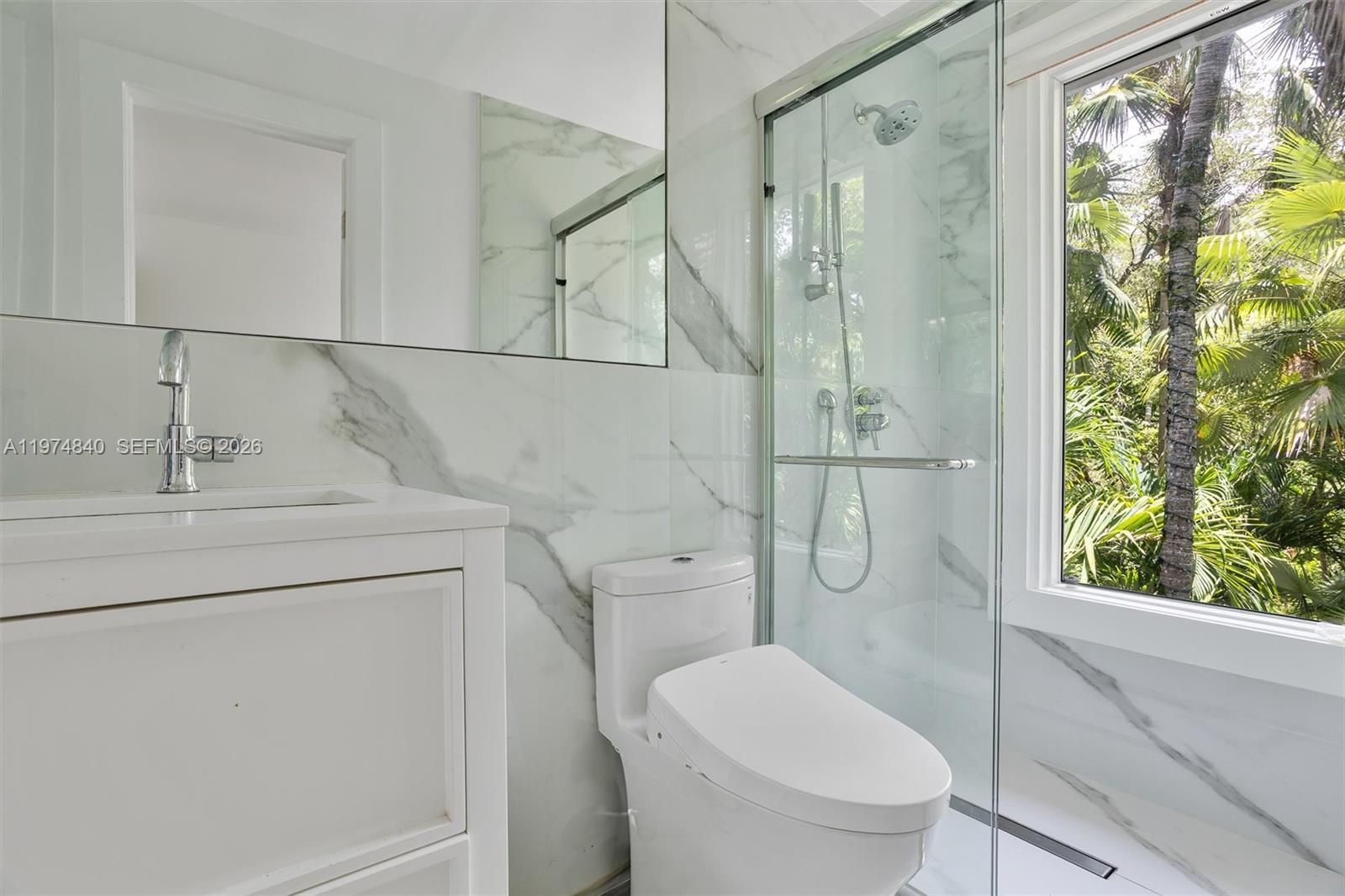 4286 Douglas Road Miami, FL 33133 - Photo 30 of 51 a bathroom with a granite countertop toilet sink and shower