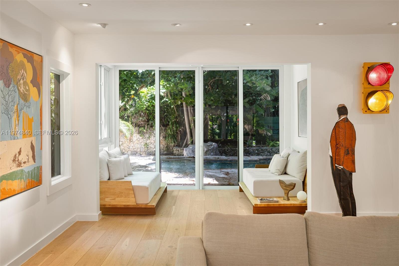 4286 Douglas Road Miami, FL 33133 - Photo 10 of 51 a living room with furniture and a floor to ceiling window