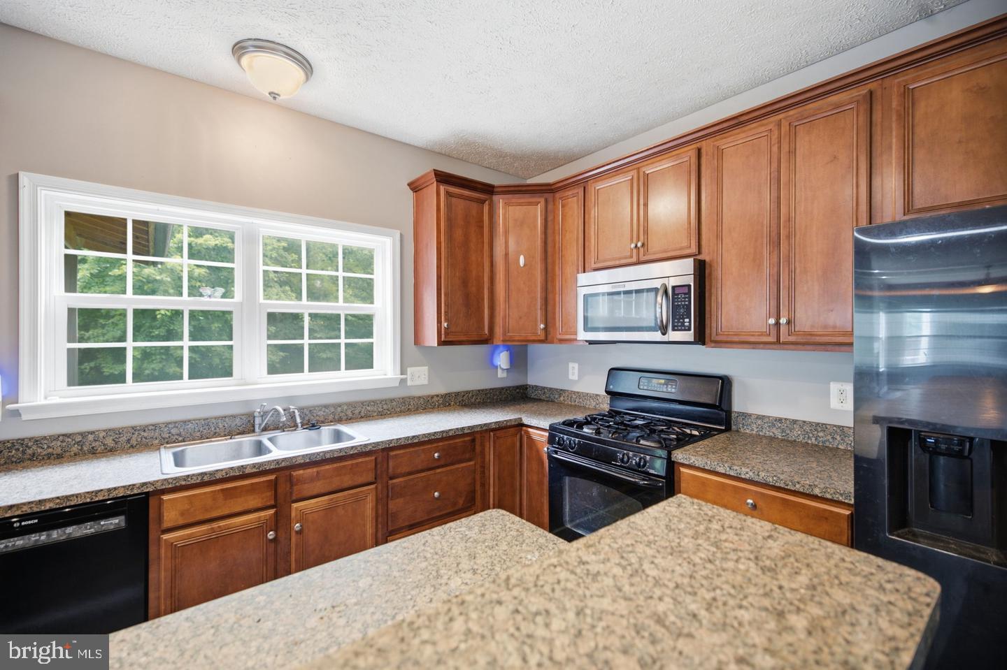 35338 Pheasant Ridge Road Locust Grove, VA 22508 - Photo 14 of 39 Modern kitchen with warm wood tones.