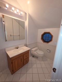 12-14 West 5th Road Queens, NY 11693 - Photo 18 of 43 Bathroom featuring lofted ceiling, vanity, light tile patterned floors, and wainscoting