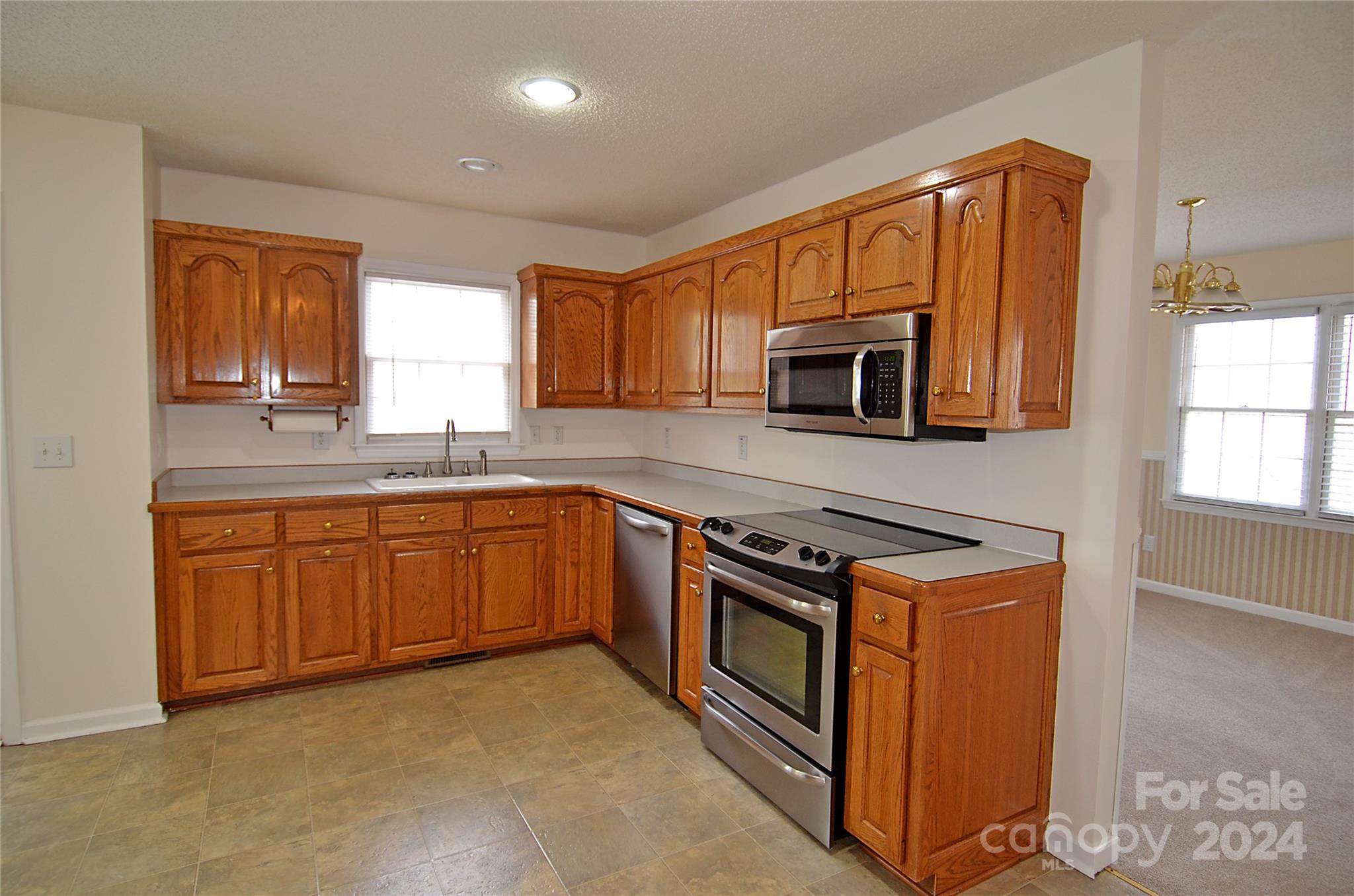 322 Cobblestone Drive Marion, NC 28752 - Photo 11 of 26 a kitchen with stainless steel appliances granite countertop a stove a sink and a microwave