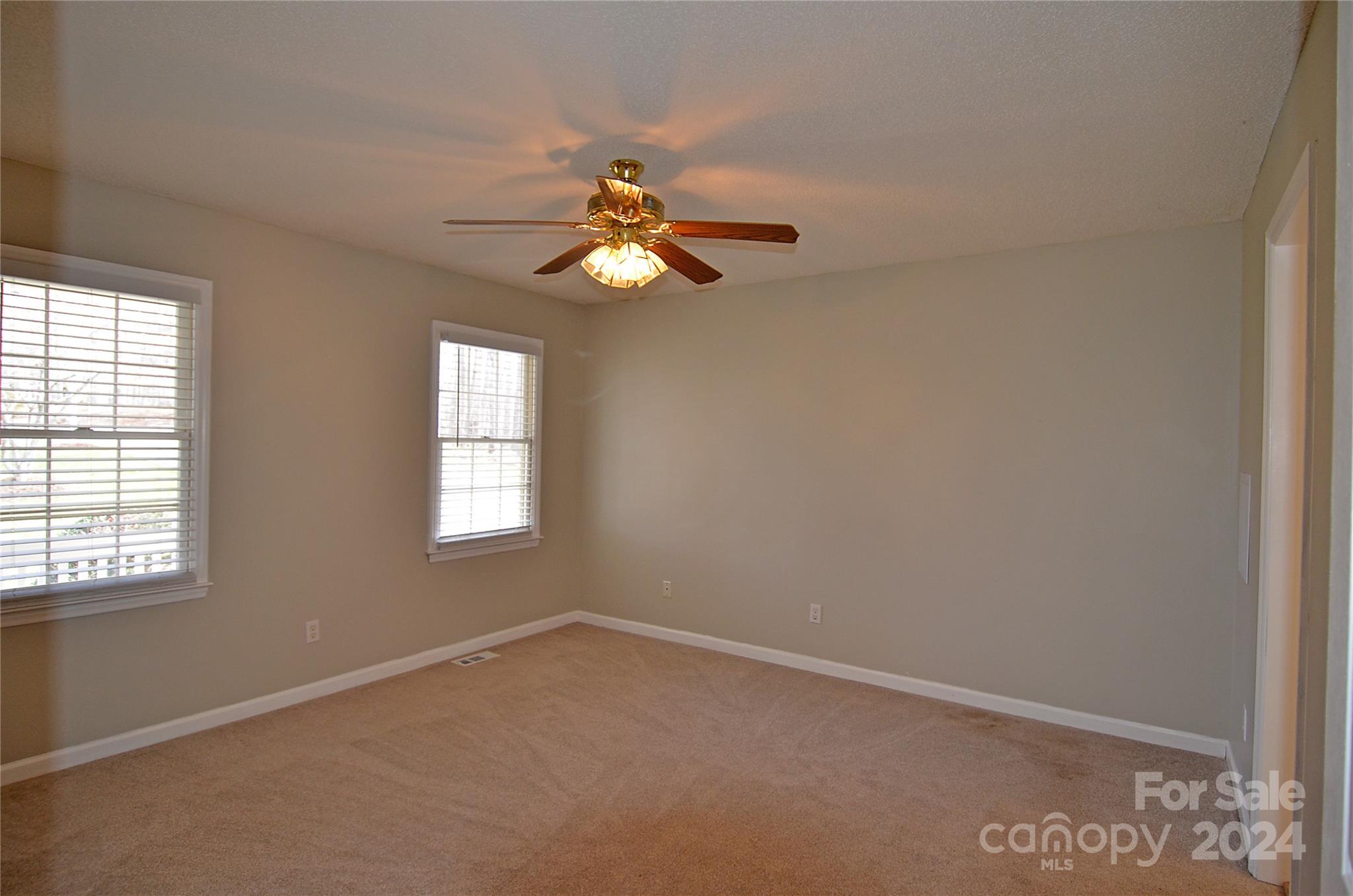 322 Cobblestone Drive Marion, NC 28752 - Photo 16 of 26 an empty room with windows and fan