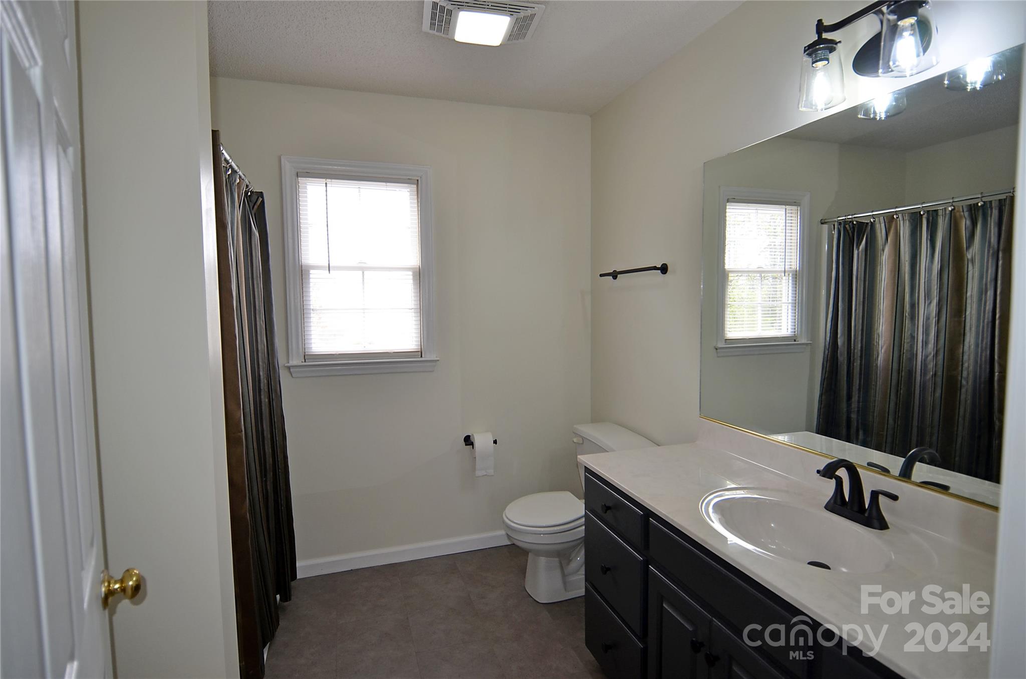 322 Cobblestone Drive Marion, NC 28752 - Photo 22 of 26 a bathroom with a sink toilet and mirror
