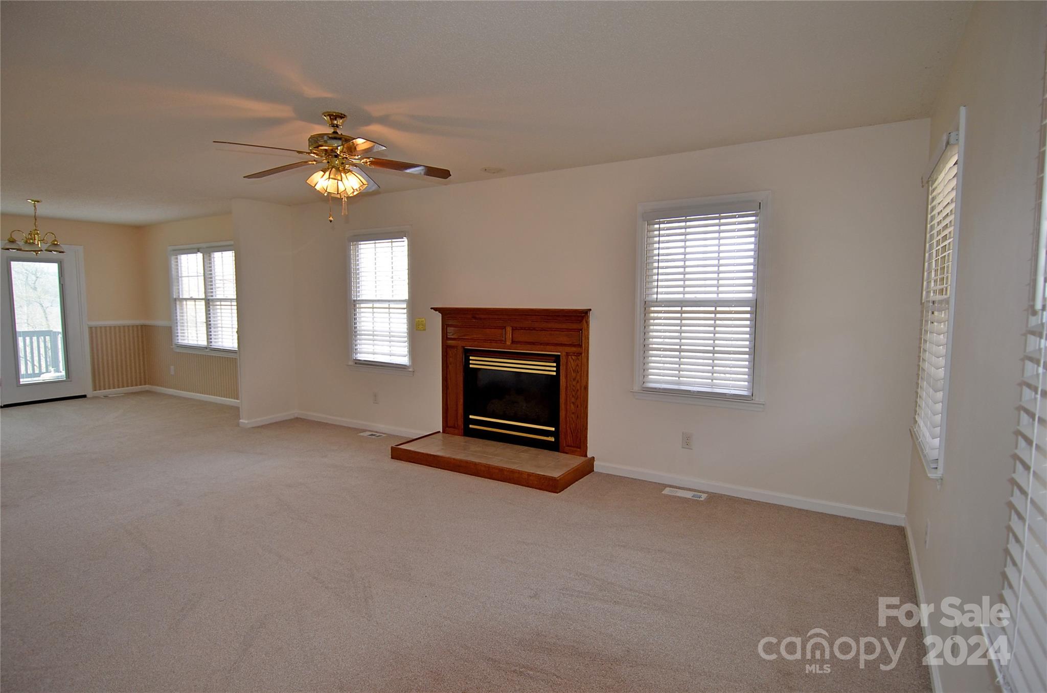 322 Cobblestone Drive Marion, NC 28752 - Photo 9 of 26 wooden floor fireplace and windows in an empty room