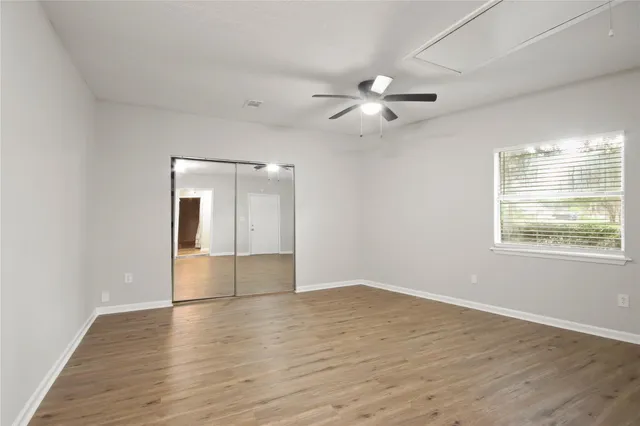wooden floor in an empty room with a window