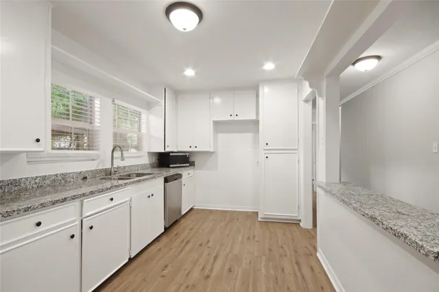 a kitchen with a sink stove and cabinets