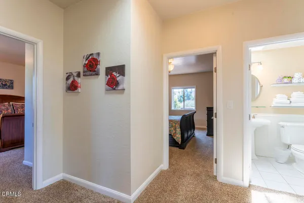 a view of a hallway and bedroom with furniture