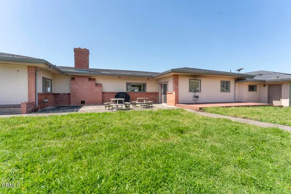 a front view of house with yard and outdoor seating