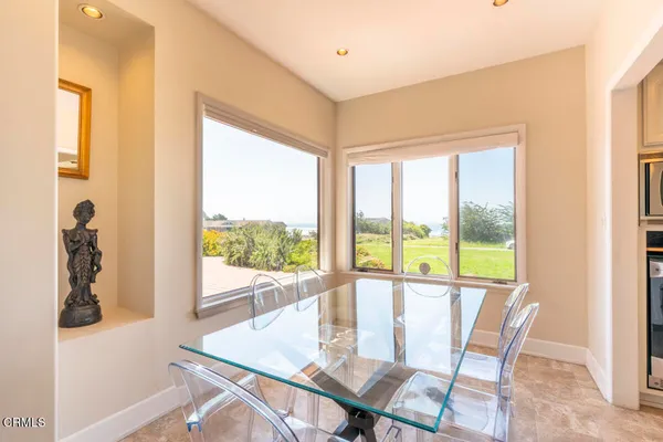 a view of a dining room with furniture and a window