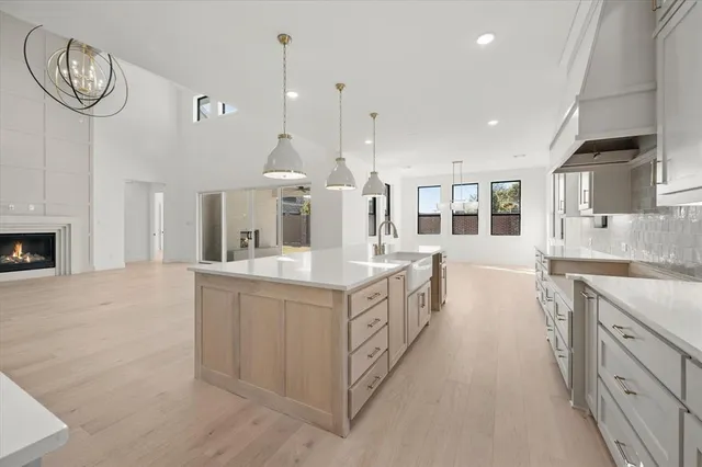 a large kitchen with stainless steel appliances granite countertop a lot of counter space and a sink