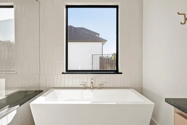 a kitchen with stainless steel appliances granite countertop a sink a stove and a refrigerator