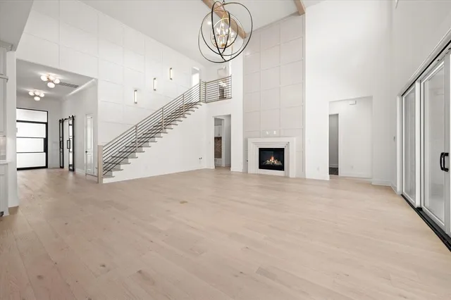 an empty room with wooden floor and white walls