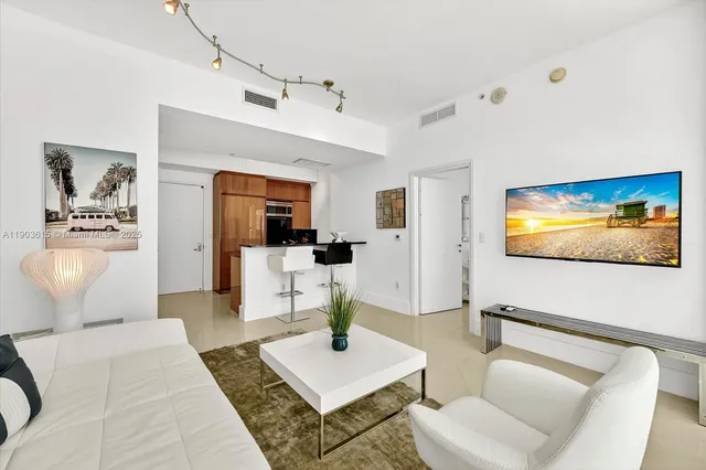 a living room with furniture a rug and a painting