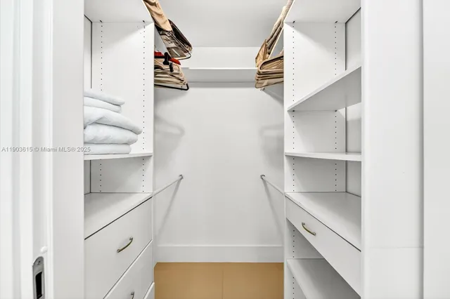 a view of walk in closet with empty racks