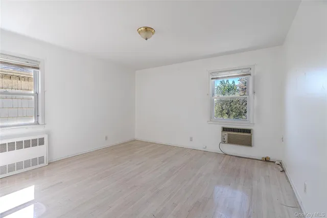 an empty room with windows and closet