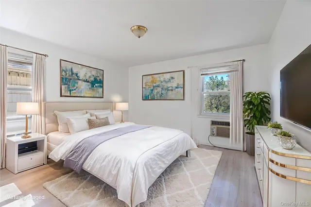 a bedroom with a large bed and a flat screen tv