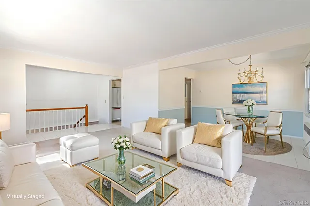 a living room with furniture and a dining table