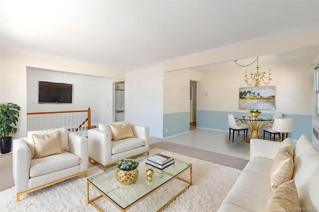 a living room with furniture and a dining table