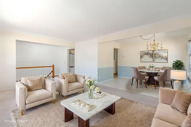 a living room with furniture and a dining table