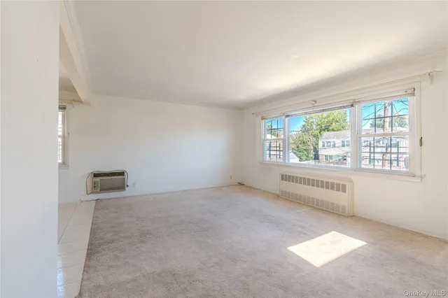 an empty room with windows and yard