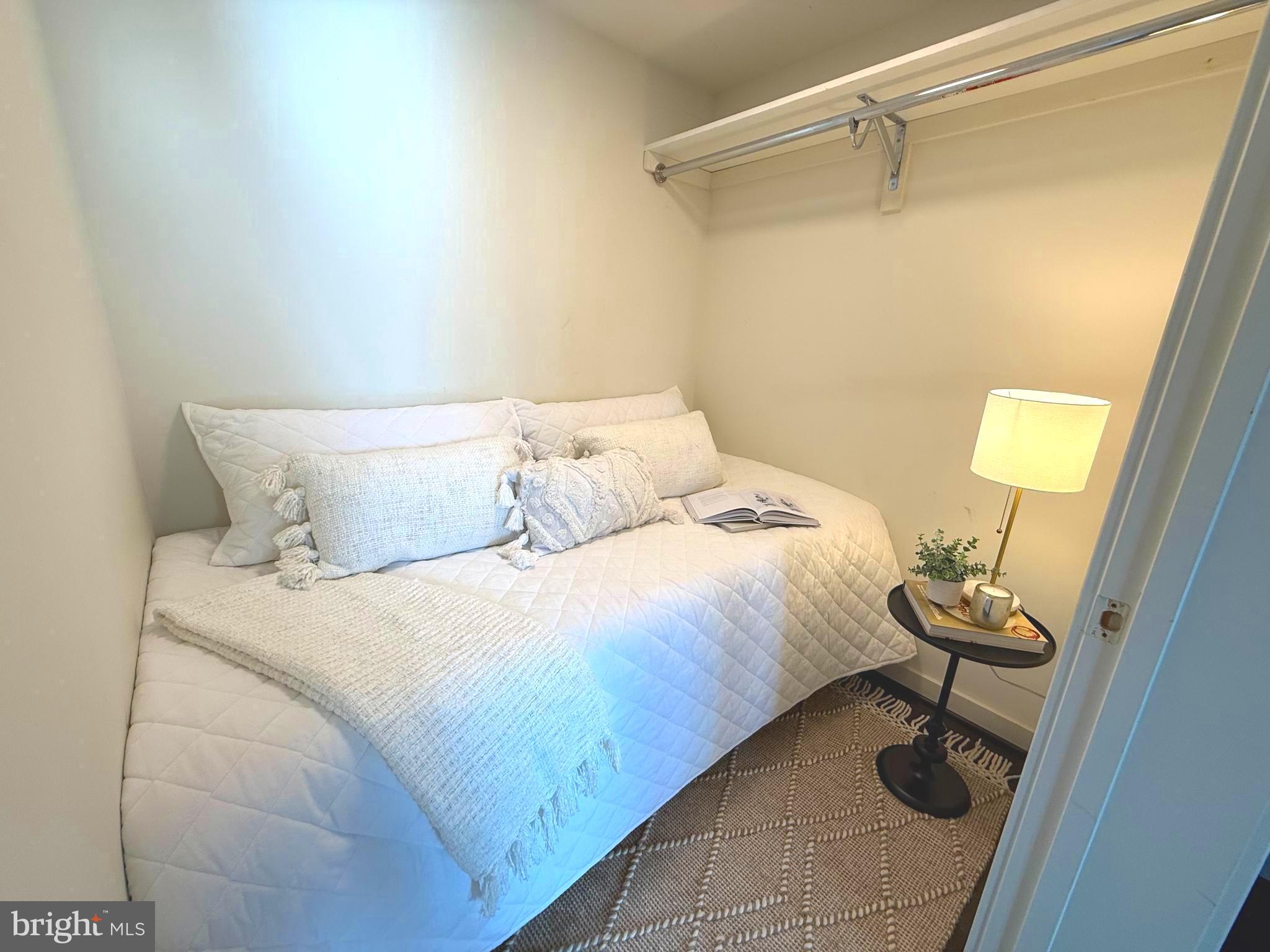 1025 First Street Southeast, Unit 907 Washington, DC 20003 - Photo 11 of 22 a bedroom with a bed and cabinets