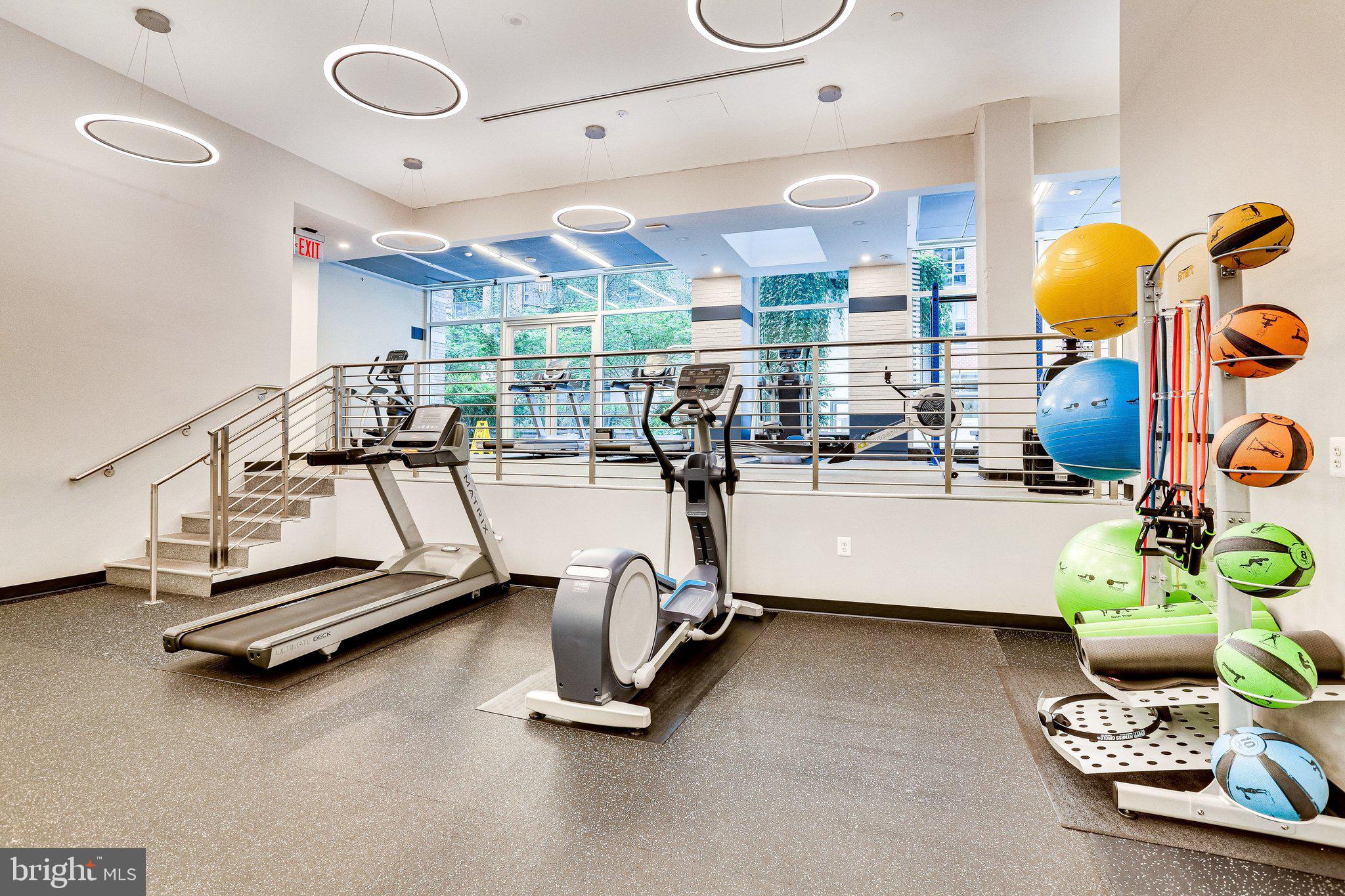 1025 First Street Southeast, Unit 907 Washington, DC 20003 - Photo 17 of 22 a room with gym equipment and a large window